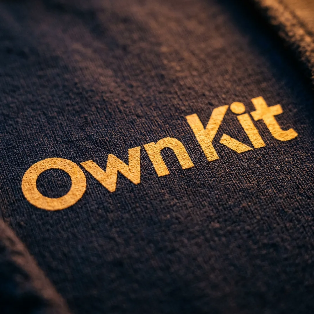 Extreme close-up of printed football shirt fabric under warm amber light